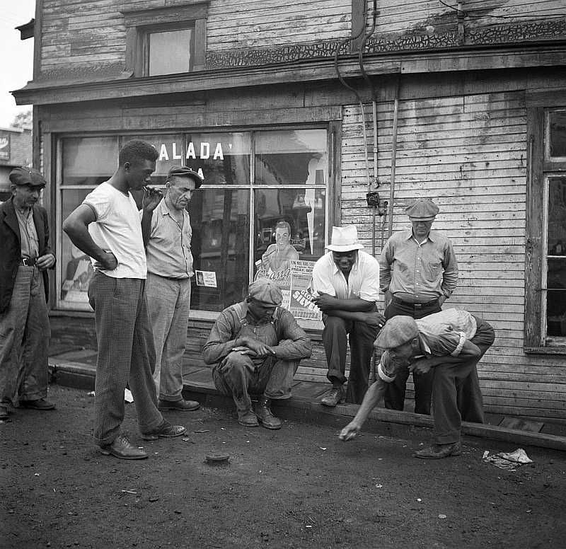 Miners shooting craps in front of company store. Osage, West Virginia   Photo: Marion Post Wolcott