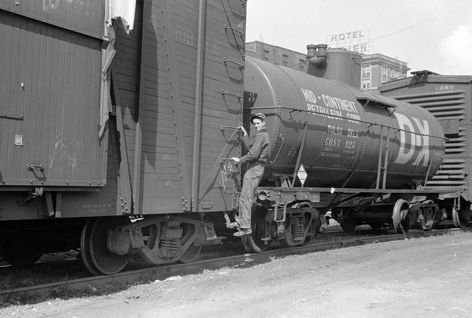 Boy hopping freight train, Dubuque, Iowa  Photo: John Vachon