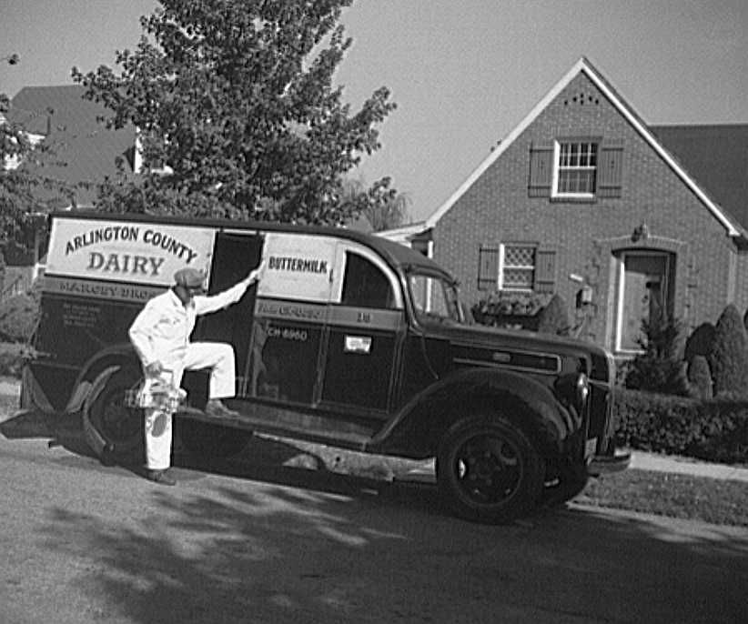 Arlington County, Virginia, dairy truck from which a driver is alighting with a tray of milk bottles  Photo: Howard Liberman